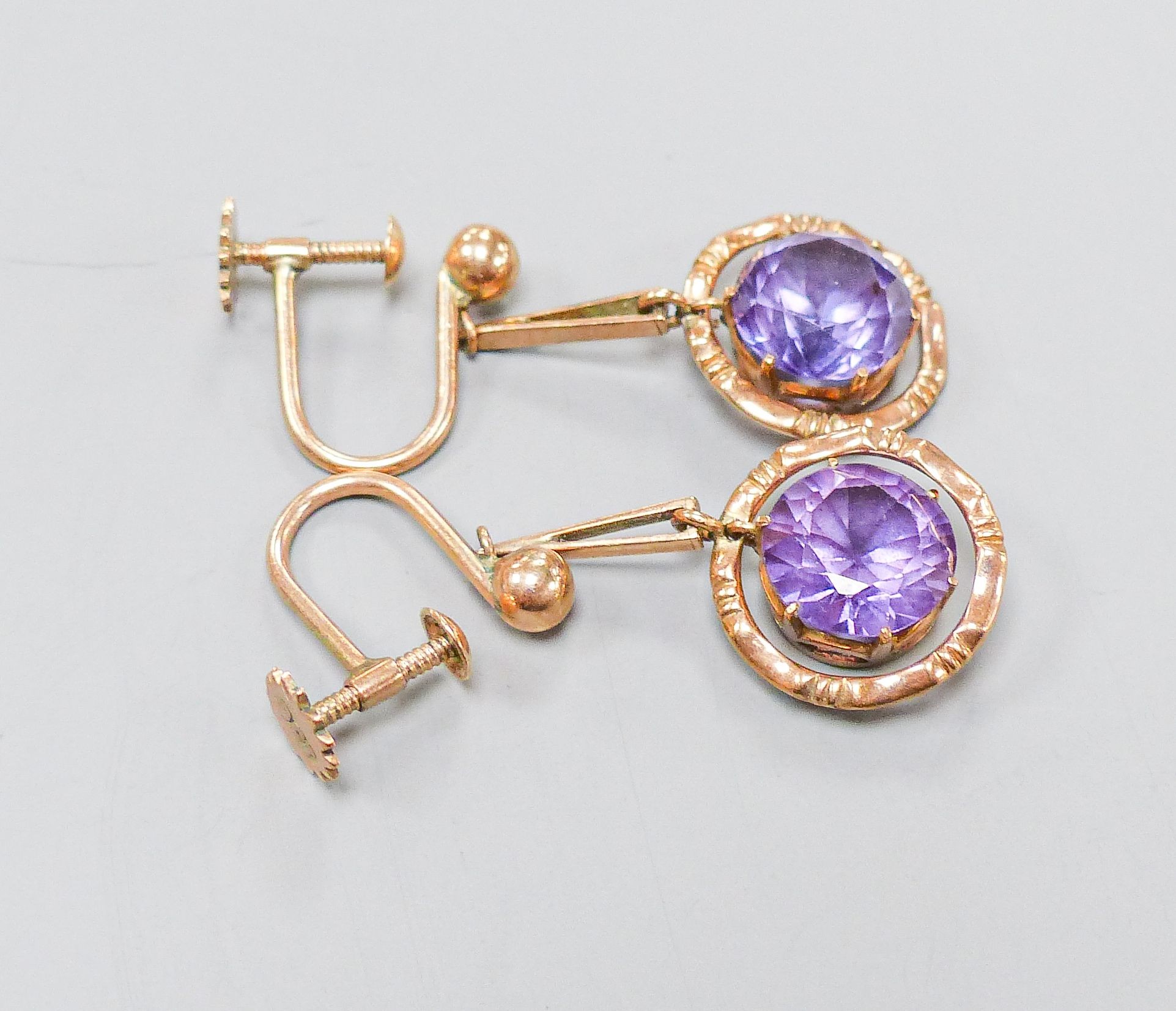 An oval cameo brooch in 9ct mount with rope-twist edge, 35mm and a pair of 9ct drop earrings set with circular synthetic sapphires, gross weight 12.8 grams.